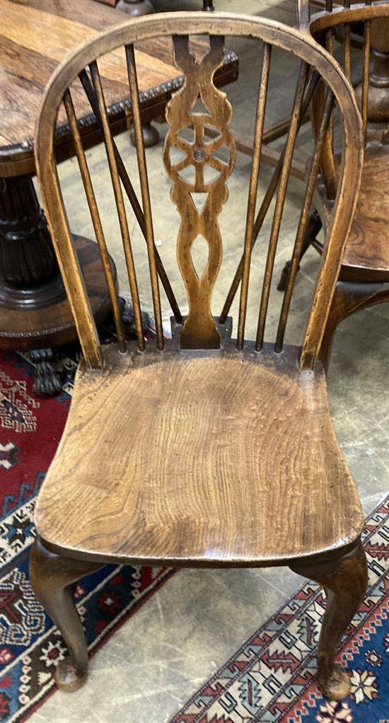 A set of eight early 20th century elm and beech Windsor wheelback dining chairs, with crinoline stretchers (two with arms)